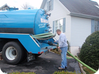 A Bailey's pumping truck arrives to pump out a septic system.