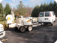 Trailer-mounted jets are used to clean septic drain field laterals.